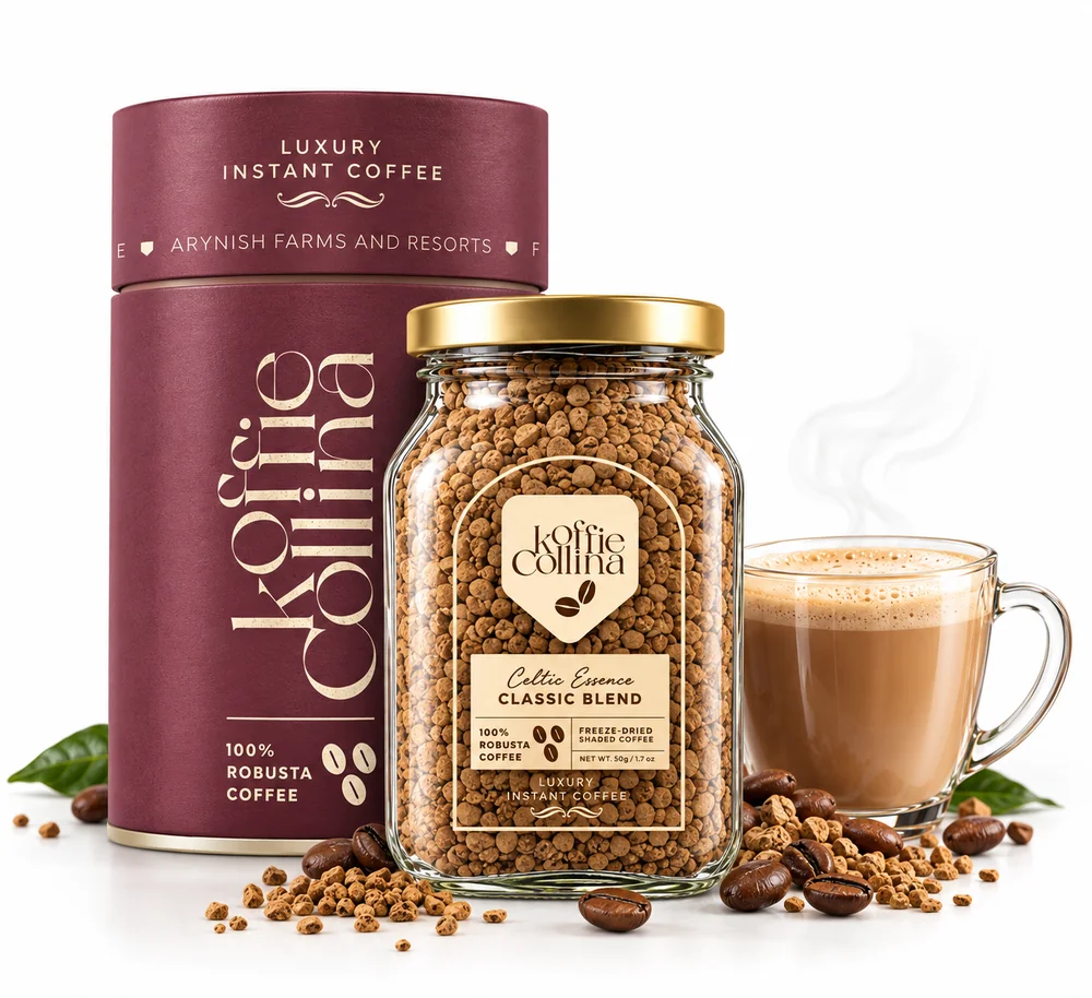 A Koffie Collina luxury instant coffee tin beside a glass jar of Celtic Essence Classic Blend freeze-dried coffee and a cup of frothy coffee, with roasted beans scattered around them.